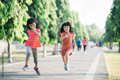 two Asian girl is jogging in the park in the morning