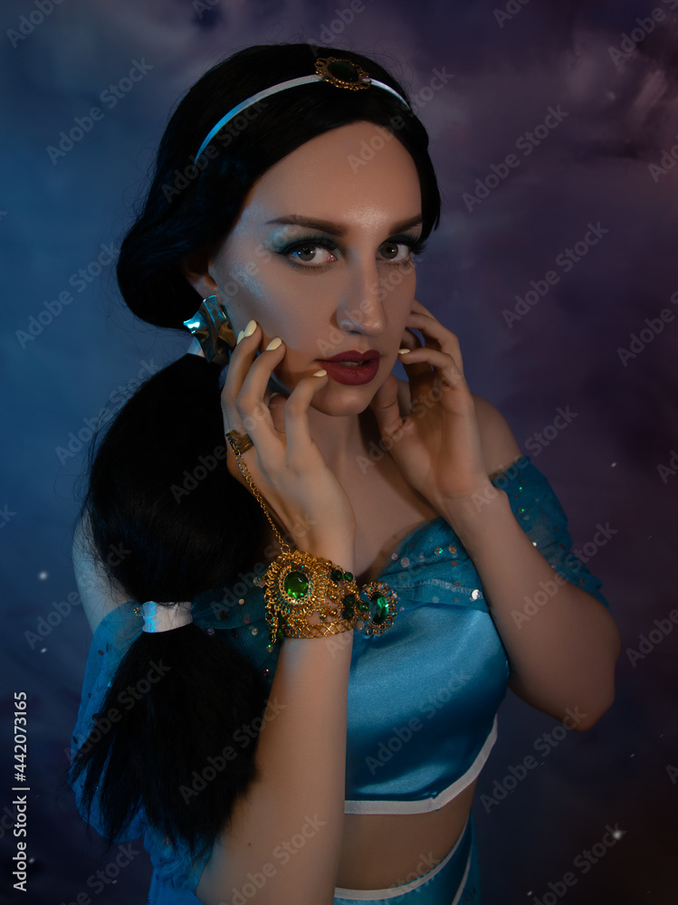 Obraz premium Beautiful princess closeup on the night sky background. Art photo.Jasmine princess cosplay. 