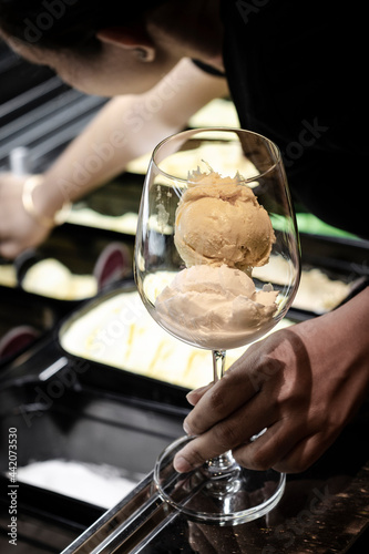 staff making italian gelato ice cream sundae in modern shop