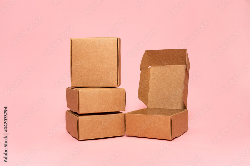 Obraz premium Self-gathering cardboard box. Delivery, moving, gift wrapping on a colored background. Place for text and logo. Brown.