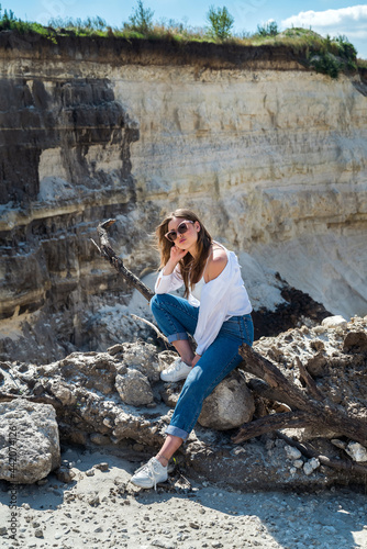 sexy beautiful young woman poses casual clothes on sand quarry © RomanR