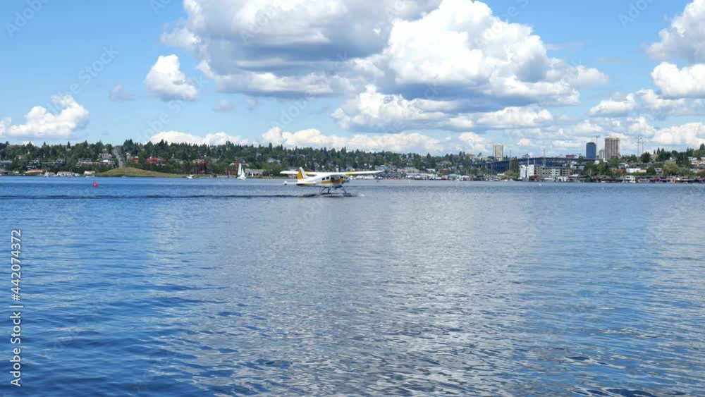 4K shot of a sailboat and a taxiing seaplane departing from Lake Union by the Museum of History and Industry MOHAI at Westlake Park, looking from South Lake Union in Seattle, Washington 4K shot of a sailboat and a taxiing seaplane departing from Lake Union by the Museum of History and Industry MOHAI at Westlake Park, looking from South Lake Union in Seattle, Washington