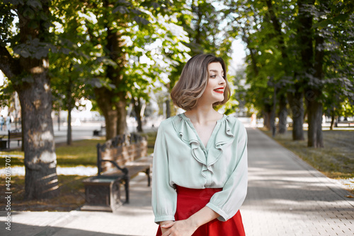cheerful woman walking in the park trees leisure lifestyle