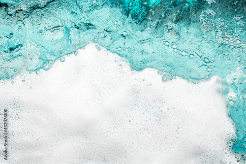 Blue sea water white foam texture background closeup, foamy ocean wave pattern, aqua bubbles surface, swimming pool backdrop, abstract summer sunny beach wallpaper, decorative frame border, copy space