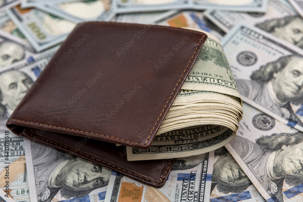 many U.S. dollars near man's wallet