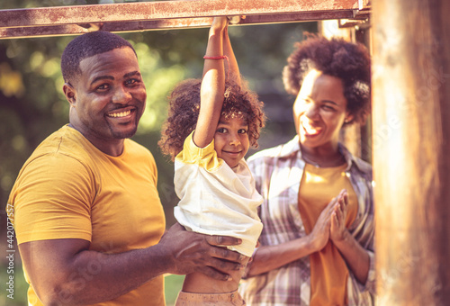 Happy African American family having fun outdoors.