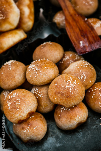 Fresh homemade bread taken from the wood oven. Close up of rustic whole meal bread rolls