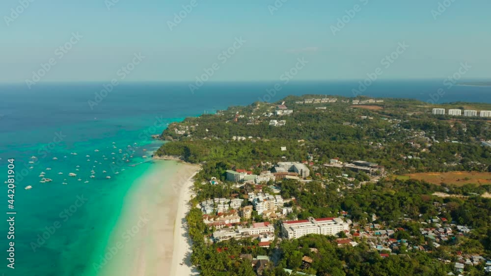 Travel concept: sandy tropical beach with hotels and tourists near the blue lagoon, aerial view, Boracay, Philippines. Seascape with beach on tropical island. Summer and travel vacation concept. Travel concept: sandy tropical beach with hotels and tourists near the blue lagoon, aerial view, Boracay, Philippines. Seascape with beach on tropical island. Summer and travel vacation concept.