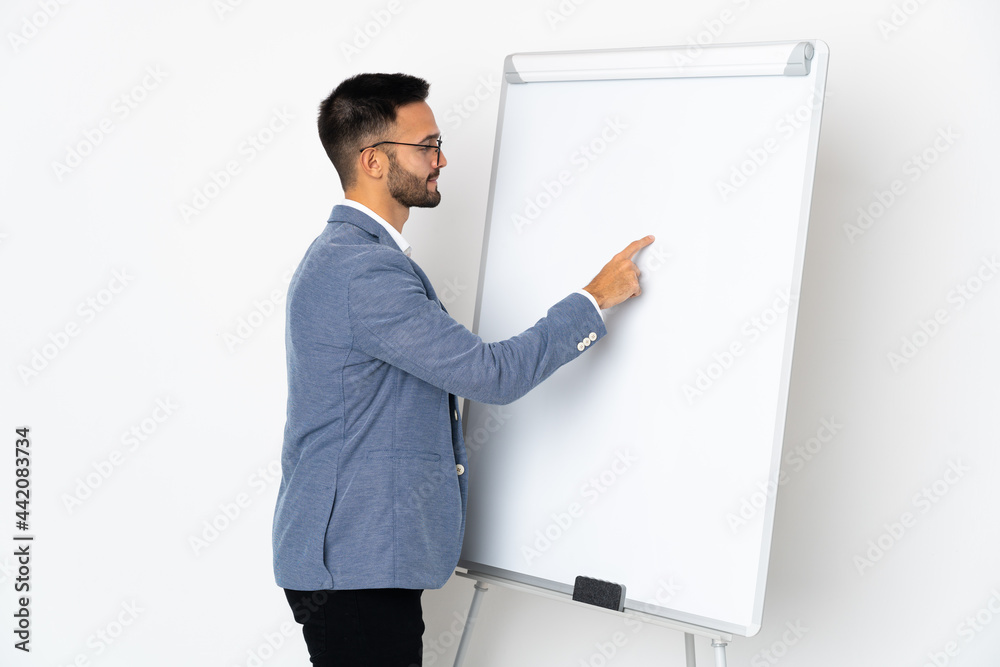 Young caucasian man isolated on white background giving a presentation on white board Young caucasian man isolated on white background giving a presentation on white board