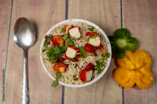 top view of paneer fried rice on a ceramic white bowl photo