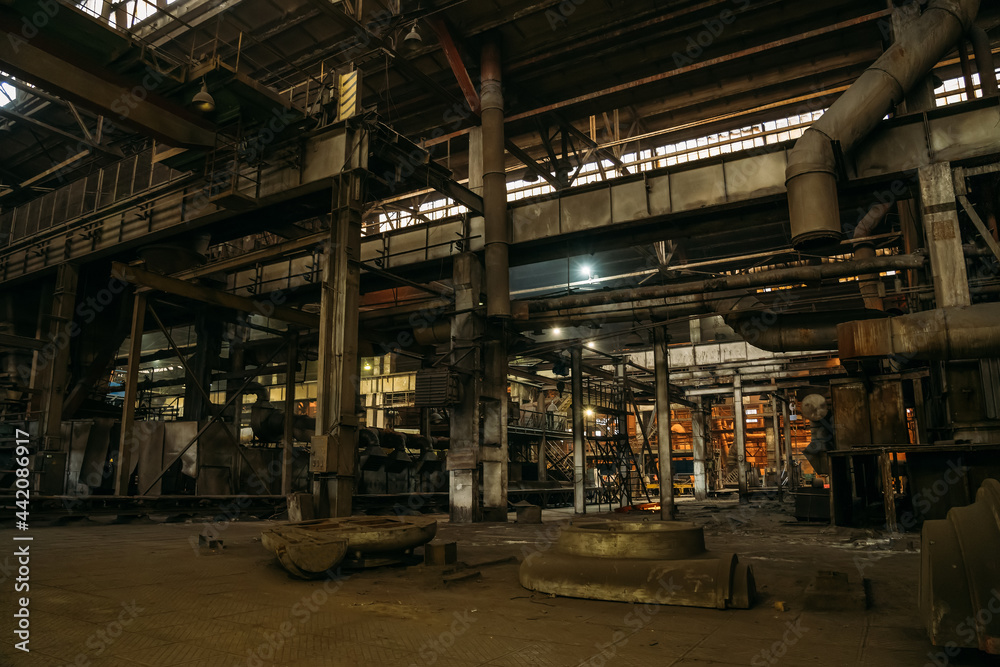 Metallurgical plant or factory inside, dark industrial interior.