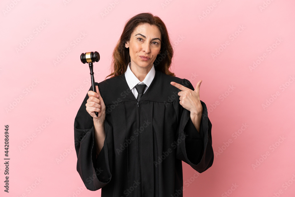 Middle aged judge woman isolated on pink background giving a thumbs up gesture Middle aged judge woman isolated on pink background giving a thumbs up gesture