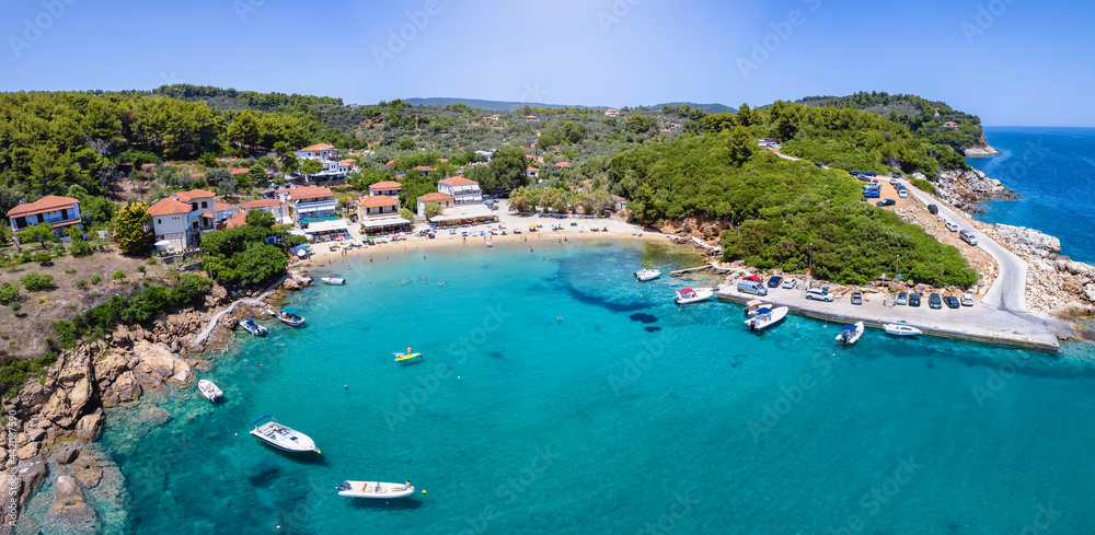 Obraz premium Aerial view to the idyllic fishing village of Katigiorgis, South Pelion, Greece, with turquoise, clear sea and sunshine during summer time