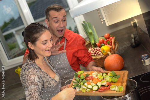 Young couple preparing a vegetables soup