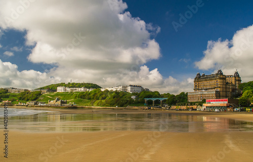 Low tide in the South Bay, Scarborough, North Yorkshire. The photo looks across the sands towards the Spa complex, Spa Bridge and Grand Hotel.