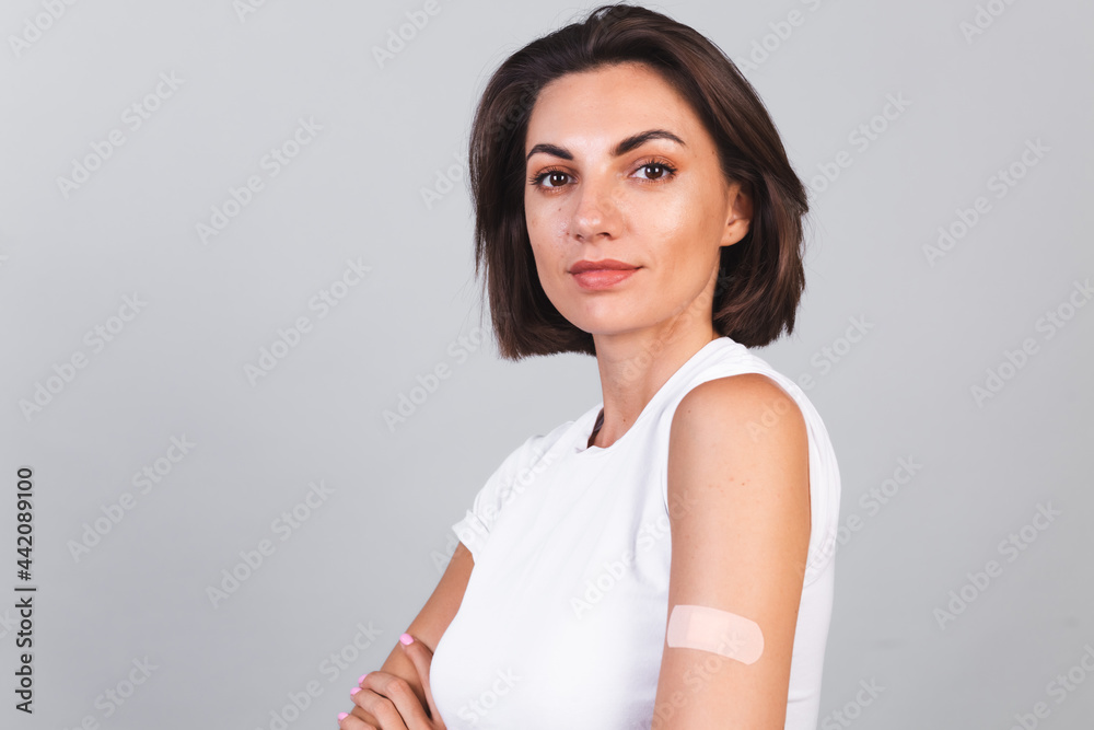 Young woman after vaccination Showing Arm With Plaster Bandage. Virus protection. COVID-2019. Young woman after vaccination Showing Arm With Plaster Bandage. Virus protection. COVID-2019.