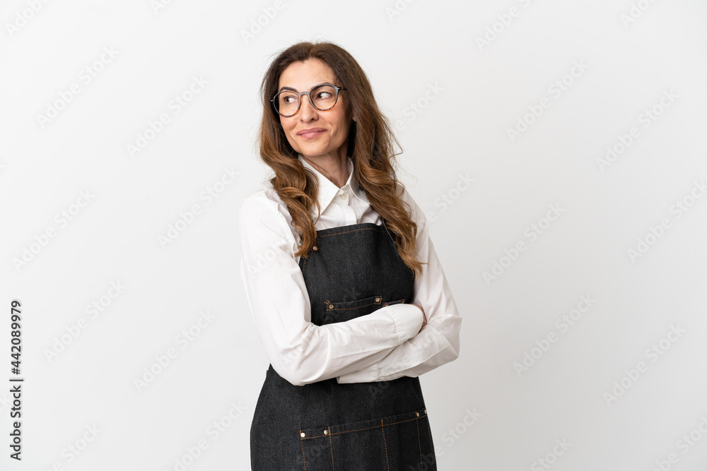 Restaurant middle aged waiter woman isolated on white background with arms crossed and happy Restaurant middle aged waiter woman isolated on white background with arms crossed and happy