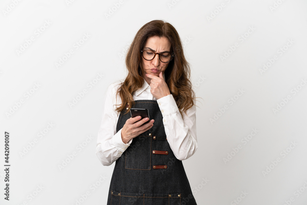 Restaurant middle aged waiter woman isolated on white background thinking and sending a message Restaurant middle aged waiter woman isolated on white background thinking and sending a message