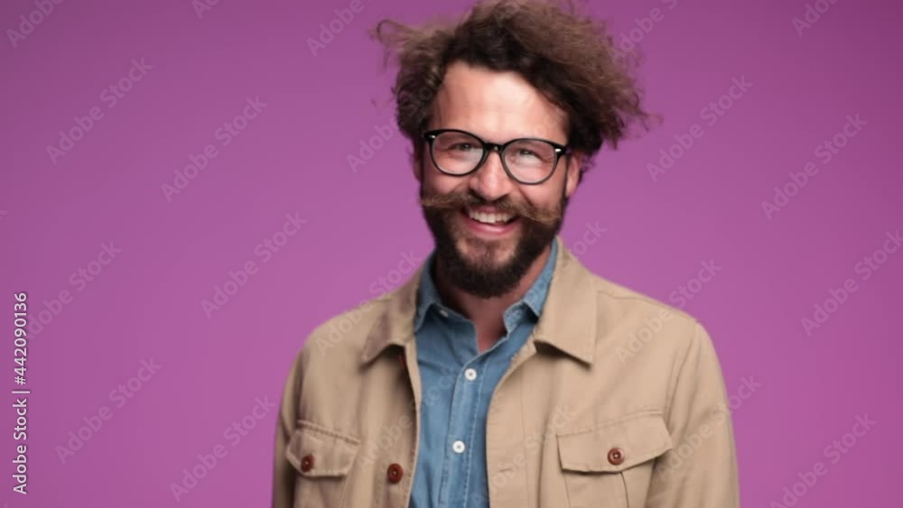 curly hair man with moustache and long beard laughing, talking glasses off, negative nodding and being upset about his sight on pink background in studio curly hair man with moustache and long beard laughing, talking glasses off, negative nodding and being upset about his sight on pink background in studio