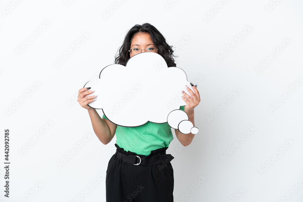Young asian woman isolated on white background holding a thinking speech bubble and hiding behind it Young asian woman isolated on white background holding a thinking speech bubble and hiding behind it