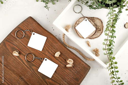Keychain mockup to display design. Key chain mock up in cozy home design. Blank rhombus white sublimation key chain photo.