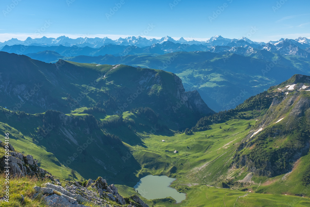 Landscape view of the swiss Alps, with blue sky in the background, shot from the 