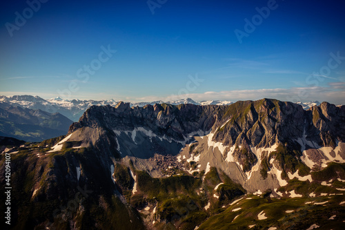 Landscape view of the swiss Alps, with blue sky in the background, shot from the 