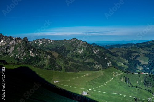 Landscape view of the swiss Alps, with blue sky in the background, shot from the 