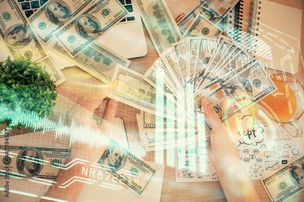 Multi exposure of Tech drawing hologram and USA dollars bills and man hands. Technology concept. Multi exposure of Tech drawing hologram and USA dollars bills and man hands. Technology concept.
