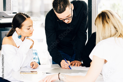 Young business colleagues working togheder  at the office photo