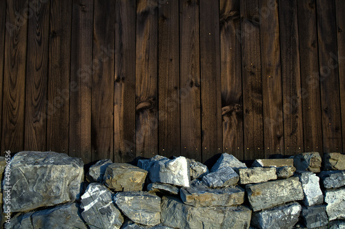 Wallpaper Mural Wall of wood and stone. Wooden background. Stones and wood. Dark theme background Torontodigital.ca