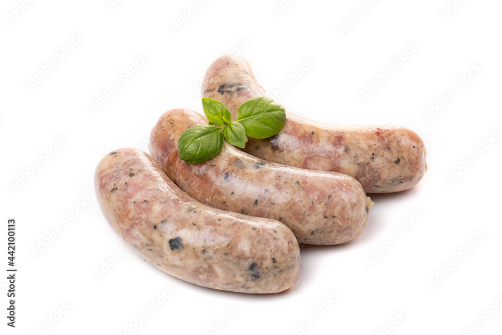 Raw or cooked homemade breakfast sausages decorated with basil leaves, isolated on a white background Raw or cooked homemade breakfast sausages decorated with basil leaves, isolated on a white background