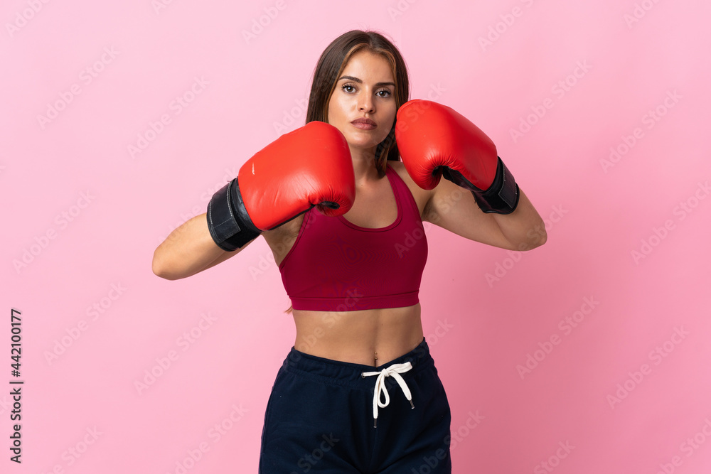 Young Uruguayan woman isolated on pink background with boxing gloves Young Uruguayan woman isolated on pink background with boxing gloves
