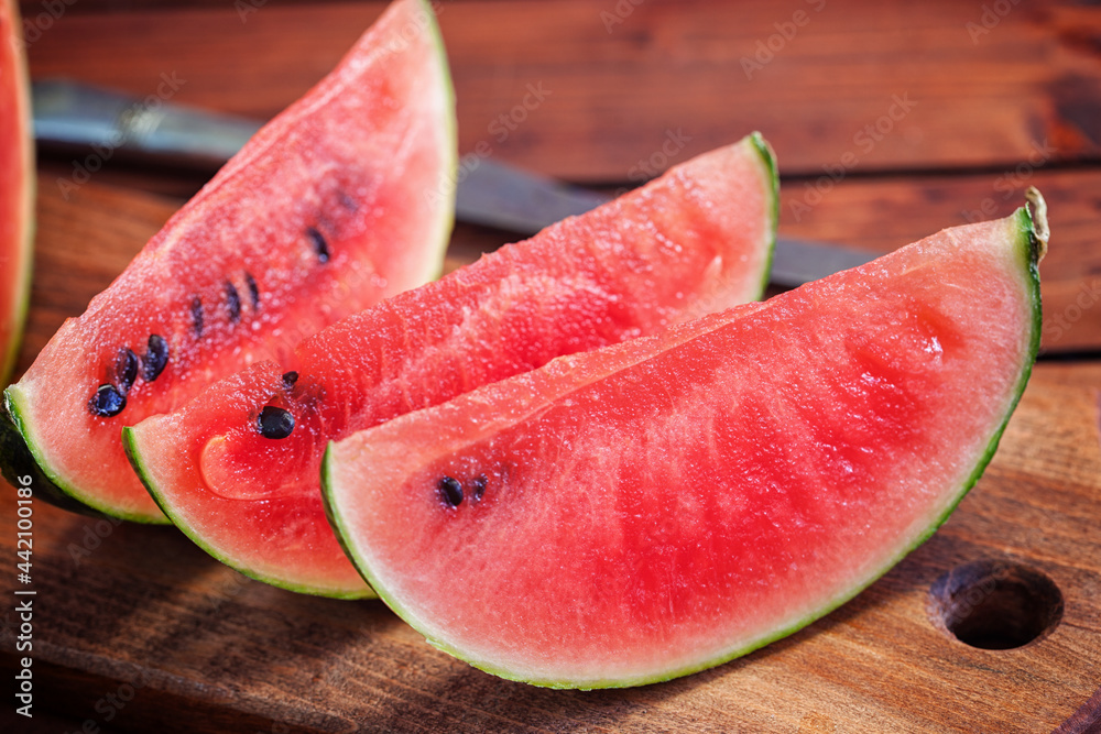 Fresh ripe sliced watermelon on wooden background Fresh ripe sliced watermelon on wooden background