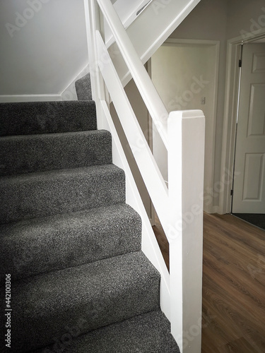 Newly renovated hallway and staircase with fresh paint and carpets - ready for sale or rental on the UK market.