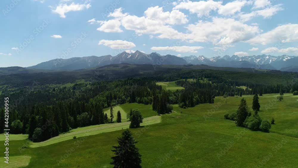 Panoramic mountain landscape, aerial view. A wide mountain range, long cinematic shot. Green mountain hills and rocky peaks in the background. Concept: Summer holidays, trekking or hiking trips. Panoramic mountain landscape, aerial view. A wide mountain range, long cinematic shot. Green mountain hills and rocky peaks in the background. Concept: Summer holidays, trekking or hiking trips.