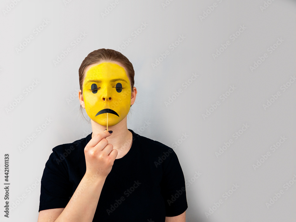 Teenage girl portrait,face painted yellow as emoticon or emoji,black