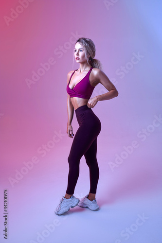 Young sexy woman with slim body poses in studio