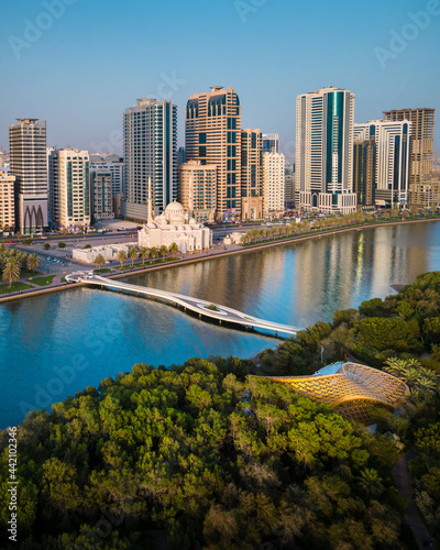 Sharjah aerial view above Al Noor island and mosque and downtown rising above Khalid lake photo