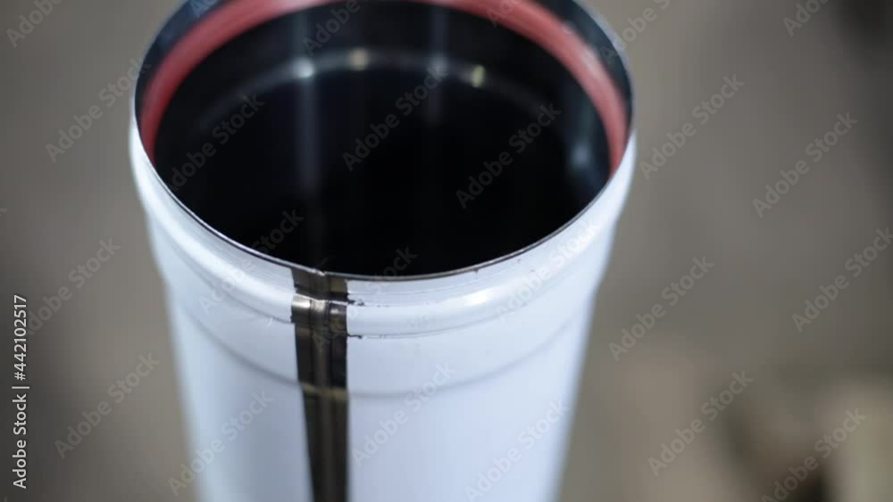 A man is installing a rubber gasket in a pipe of the air ventilation