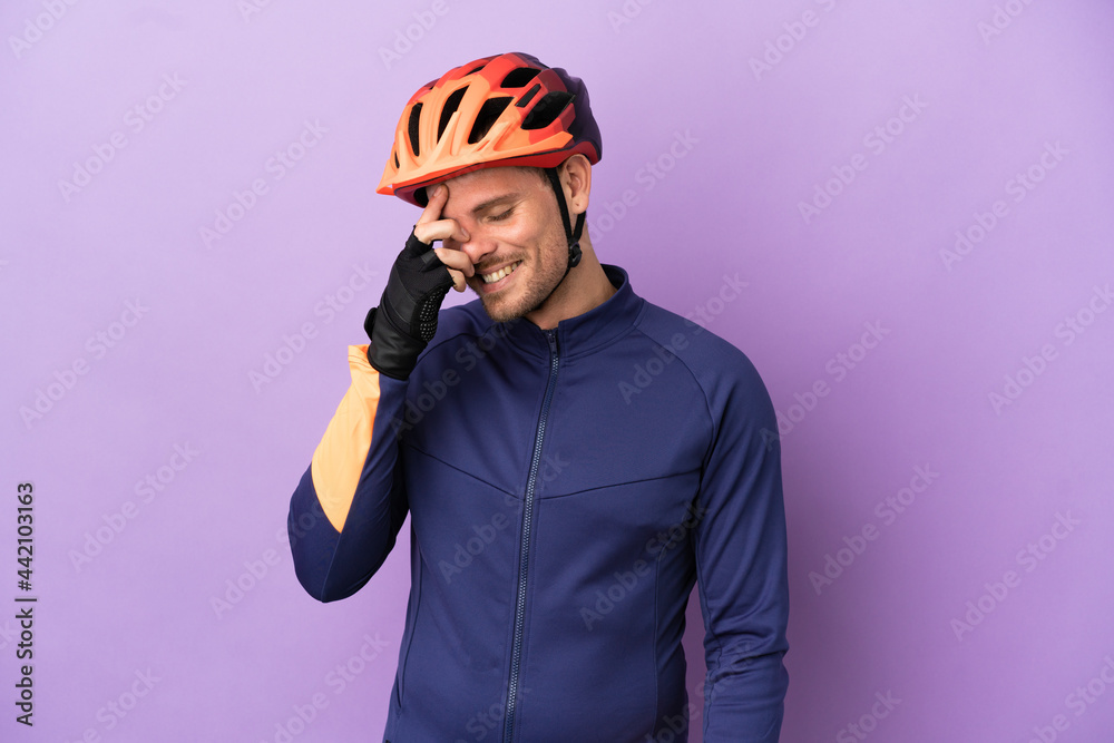 Young Brazilian cyclist man isolated on purple background laughing Young Brazilian cyclist man isolated on purple background laughing