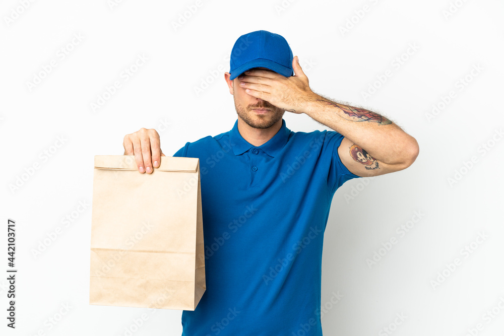 Brazilian taking a bag of takeaway food isolated on white background covering eyes by hands. Do not want to see something Brazilian taking a bag of takeaway food isolated on white background covering eyes by hands. Do not want to see something