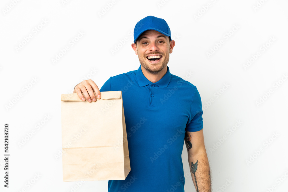 Brazilian taking a bag of takeaway food isolated on white background with surprise facial expression Brazilian taking a bag of takeaway food isolated on white background with surprise facial expression