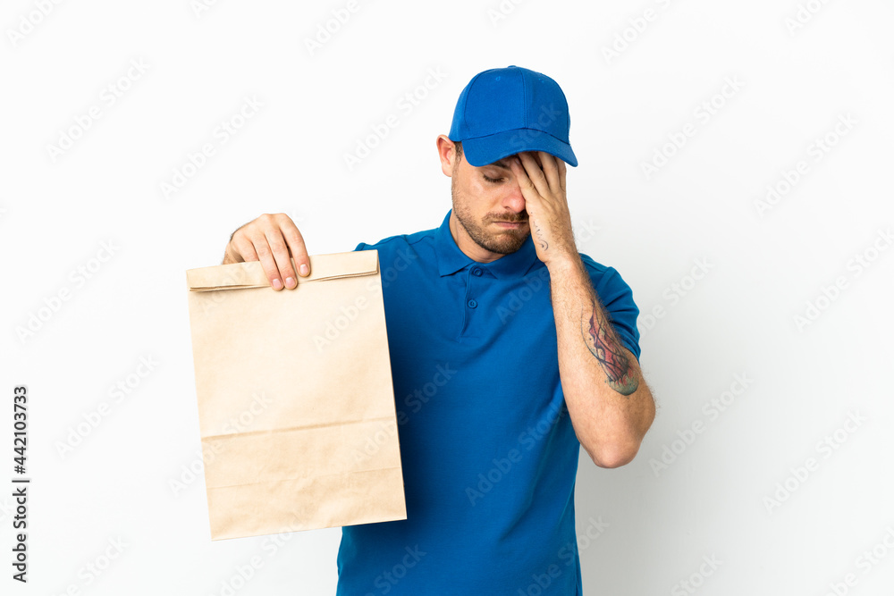 Brazilian taking a bag of takeaway food isolated on white background with tired and sick expression