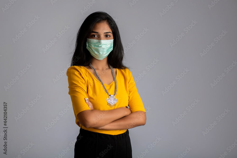 Portrait of a young girl woman posing on gray background Portrait of a young girl woman posing on gray background