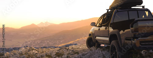 Modern off road truck in a remote location enjoying the sunset 3d render photo