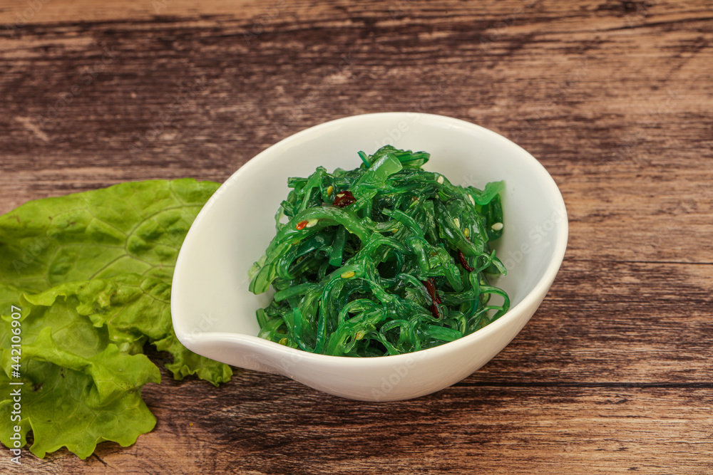 Green Chuka Seaweed Salad Isolated on White Background Top View. Wakame Sea Kelp Salat Green Chuka Seaweed Salad Isolated on White Background Top View. Wakame Sea Kelp Salat