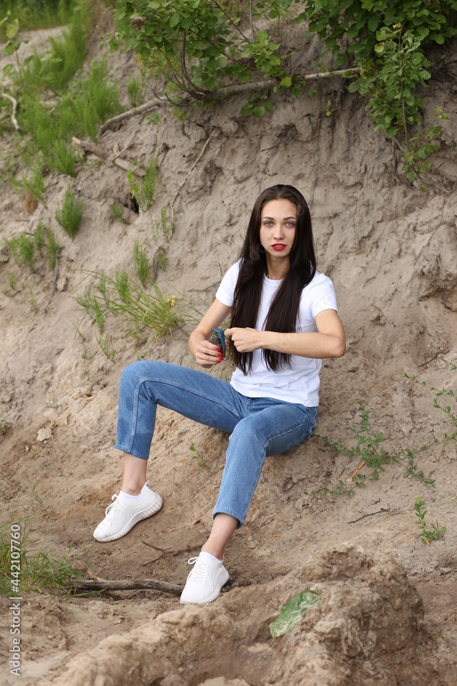 Beautiful woman playing with grenade outside Beautiful woman playing with grenade outside