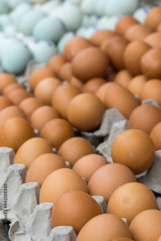 Pile of chicken eggs and duck eggs on a traditional market shelf display. Pile of chicken eggs and duck eggs on a traditional market shelf display.