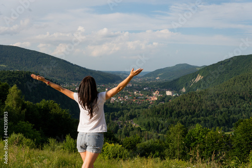 girl in the mountains enjoys the panorama of the mountains